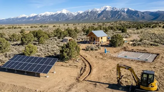 Rural Costilla County property with a ground mounted solar array, open acreage, and a developing homesite