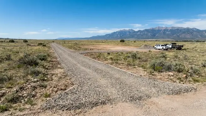 Newly improved gravel driveway and private access road across rural Costilla County property