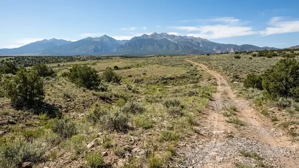 Rural Costilla County acreage showing terrain, vegetation, drainage patterns, and ground conditions relevant to site planning