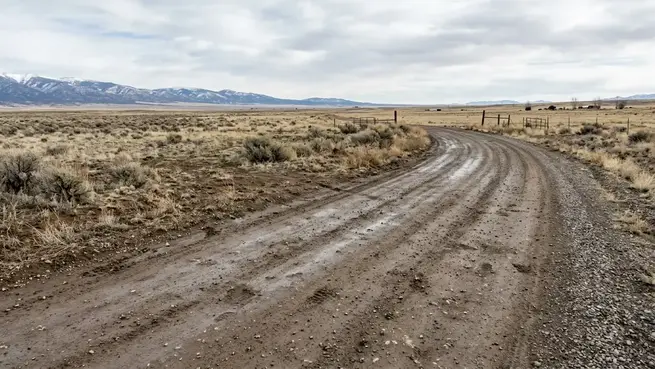 Unpaved rural access road showing natural ground and gravel conditions on an undeveloped Costilla County property